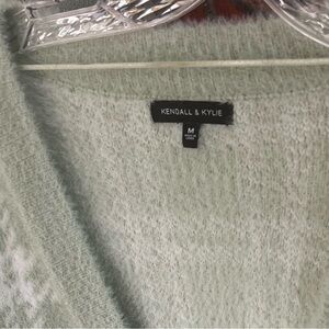 Cute cardigan! You can wear this with just a tank top under breath! It’s fuzzy